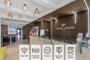 a hotel lobby with signs on the wall at Hotel Adler in Friedrichshafen