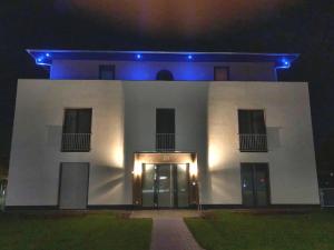 a white building with blue lights on it at Luxus_SPA_OG_Fewo DREAMTIME _WE 3_ in Göhren-Lebbin