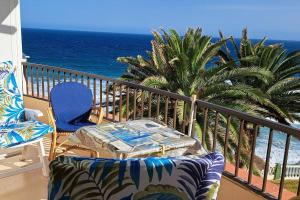 a balcony with a table and chairs and the ocean at Acapulco Playa beautiful SeaView in Nerja
