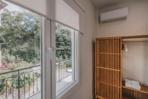a room with a large window and a balcony at E & G Figareto Apartments 6 in Kanoni