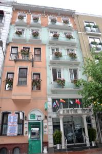 a tall building with windows and flower boxes on it at Antik Ipek Hotel in Istanbul