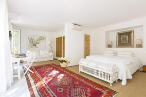 a living room with a bed, chair, and table at Casa la Concha Boutique Hotel in Marbella