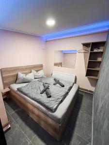 a bedroom with a bed with two shoes on it at KK Apartment Bajša 