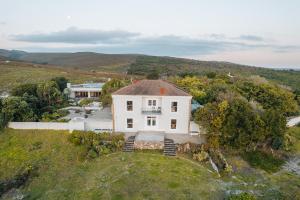 an aerial view of a white house on a hill at Farm 215 Private Nature Reserve in Uilenkraal
