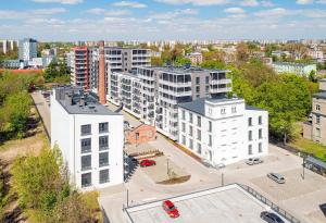 an aerial view of a city with white buildings at Lodz4rent - Premium Apartments - MANUFAKTURA D77 - Parking - Wakacje 2024 in Łódź