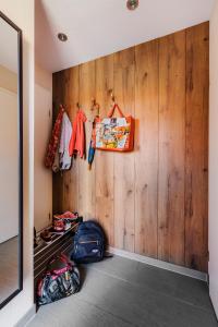a walk in closet with wooden walls and clothes at Ferienhaus Hödur in Hasselfelde