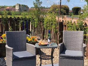two chairs and a table on a patio at Sarah's Cottage in Bridlington