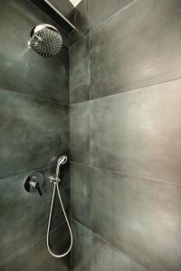 a shower with a shower head in a bathroom at Babbo in Vlorë +42 photos