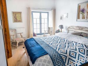 a bedroom with a bed with a blue pillow on it at La ferme de la Chapelle - Gîte et chambres d'hôtes in Cherain