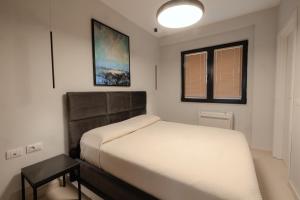 a small bedroom with a bed and a window at Babbo in Vlorë