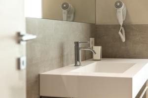 a white sink in a bathroom with a mirror at Palazzo Betteloni in Bardolino