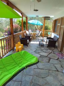 a patio with an umbrella and a table and chairs at Jimmys Nature House in Metamorfosi