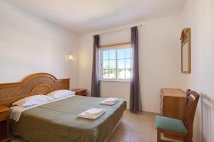 Ένα ή περισσότερα κρεβάτια σε δωμάτιο στο Algarve apartments I +14 φωτογραφίες