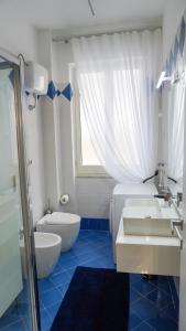a bathroom with a sink and a toilet and a shower at Donna Elena House in Maiori