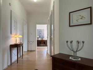 a hallway with white walls and a wooden table and a hallway with at The Classy Sassy in Ljubljana +15 photos