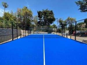 a tennis court with a blue court at Villa Alexandra Luxury Apartments by Sweet Inn in Cannes