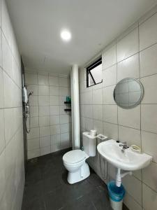 a bathroom with a toilet and a sink at New Cozy The Sun Homestay at Sg Nibong Bayan Lepas Factory Area in Bayan Lepas