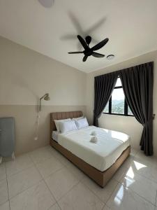 a bedroom with a bed with a ceiling fan at New Cozy The Sun Homestay at Sg Nibong Bayan Lepas Factory Area in Bayan Lepas