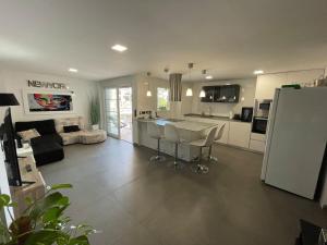 cocina y sala de estar con encimera y nevera en Seaside Apartment Retreat en Benicàssim