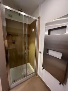 a shower with a glass door in a bathroom at Dolce Vita Guest House in Rome