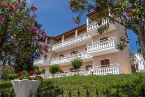 a building with balconies on a hill with flowers at Corfu Panorama by Estia in Moraitika