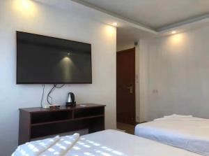 Postel nebo postele na pokoji v ubytování Yaou Hotel