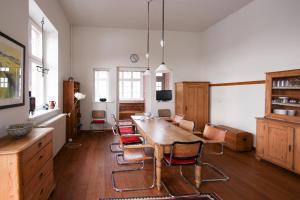 a dining room with a wooden table and chairs at Alter Bahnhof Bresewitz in Bresewitz