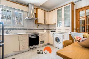 a kitchen with white cabinets and a dishwasher at #128 Number 10 Villa by Home Holidays in Albufeira