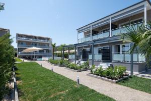 an exterior view of a building with plants at Astra Sarti Luxury Suites in Sarti