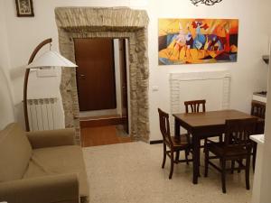 una cucina e una sala da pranzo con tavolo e sedie di "In Centro" a Campagnano di Roma