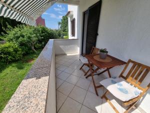 a small patio with two chairs and a table at Apartment Marina in Porat