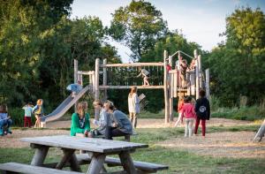 a group of children playing on a playground at Huttopia Saumur in Saumur