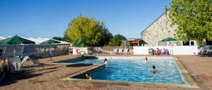 a group of people playing in a swimming pool at Huttopia Saumur in Saumur