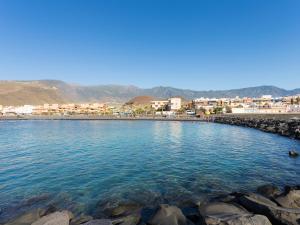 a body of water with buildings in the background at Live Puertito Neptune Beach in Puertito de Güímar +58 photos