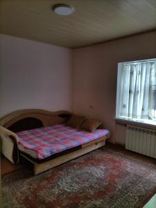 A bed or beds in a room at Гостевой дом У Матвея
