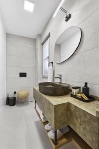 a bathroom with a sink and a mirror at Panda Alacati Hotel in Alaçatı