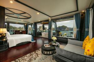 a hotel room with a bed and a couch at La Regina Grand Cruise in Ha Long