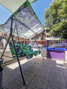 a colorful umbrella sitting on top of a ride at Guesthouse "Slavkova" in Sozopol