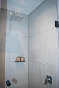 a bathroom with a shower with a glass door at 101 Bridgewater Apartment in Cape Town +20 photos