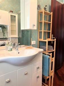 a bathroom with a white sink and a shelf at Casa in Prato in Padova