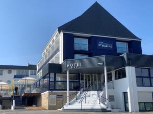 a hotel with a black and white building at L'Escale Marine, The Originals Relais in Crozon