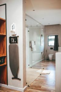 a bathroom with a shower and a glass door at Burundi Palace Boutique Hotel in Bujumbura