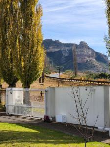 a white fence with a mountain in the background at Clarens, Paddocks 23 in Clarens