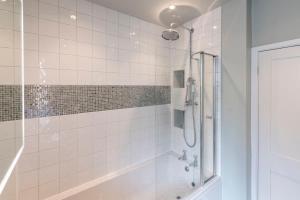 a bathroom with a shower with a glass door at Norfolk House - Stamford in Stamford +36 photos
