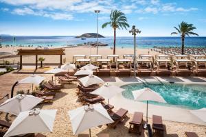 a resort with a pool and beach with chairs and umbrellas at Sol Wave House All Suites in Magaluf