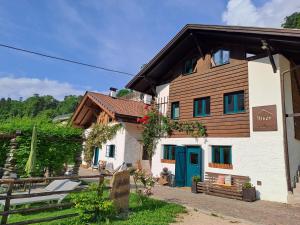 a building with a blue door on the side of it at Chalet Passeier - RIVER in Saltusio