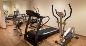 a gym with several tread machines in a room at Quiet Hotel Al Shatee in Jeddah