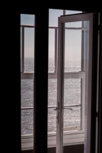 an open window with a view of the ocean at San Clu Hotel, Bar & Brasserie in Ramsgate