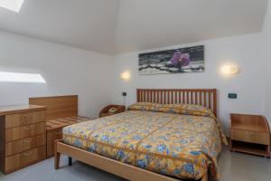 a bedroom with a bed and wooden furniture at Residence Villa Alda in Pietra Ligure