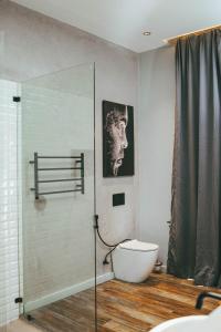 a bathroom with a glass shower and a toilet at Burundi Palace Boutique Hotel in Bujumbura